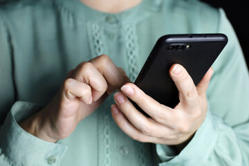 Woman using smartphone, mobile phone in female hands close up. Concept of online addiction, sms, social media