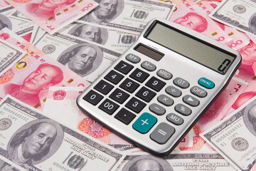 Fototapeta premium US dollar and China rmb bills with calculator