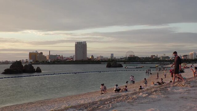 CHTAN-CHO, OKINAWA, JAPAN - AUG 2021 : View of Araha beach (Ocean or sea) in sunset time. Wide view, long time lapse shot, dusk to night. Summer holiday, vacation and resort concept shot.