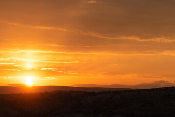 Fototapeta na wymiar Amazing orange sunrise in Cappadocia, Turkey with soft selective focus. Beauty of nature concept