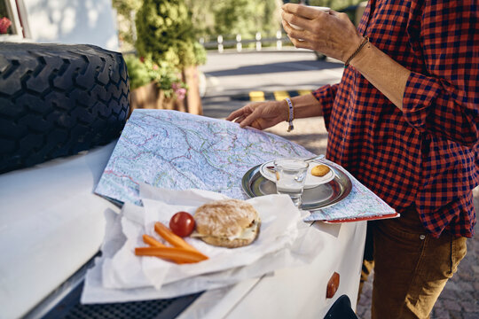 Woman with map on off-road vehicle at vacation, Schnalstal, South Tyrol, Italy