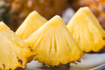 fresh pineapple(Ananas comosus) with slices on wooden table
