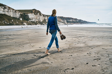 Tourist walking on sand at beach
