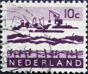 Netherlands - circa 1963: a postage stamp from the Netherlands, showing activities at the Dutch dike construction project: Delta Works with sand excavators, dike fortifications and ships