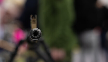 The muzzle with the sight of an army assault rifle is pointed at the camera. Close-up of the...