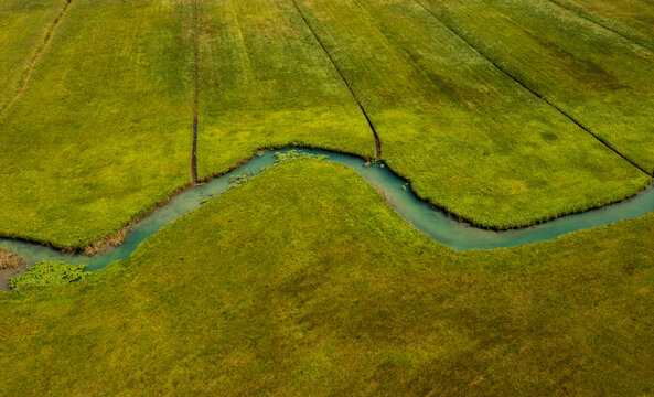 Drone view of Zeller Ache river flowing through green meadow