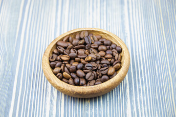 Coffee in a wooden bowl before grinding.