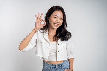 beautiful Young asian woman smiling with okay hand gesture