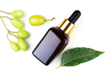 Neem oil in bottle and neem leaf with fruit isolated on white background, top view. Neem oil excellent moisturizing oil and contains various compounds that have insecticidal and medicinal properties.