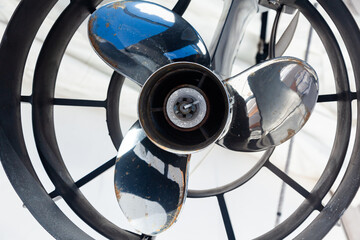 Motor propeller for motor yachts and boats in a protective steel casing on a boat, close-up.