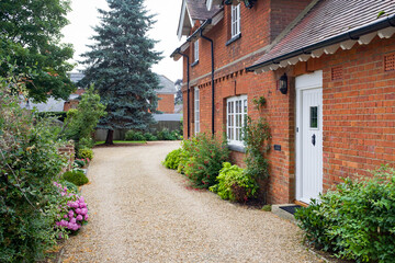 Fototapeta na wymiar Garden and gravel driveway, English country house UK