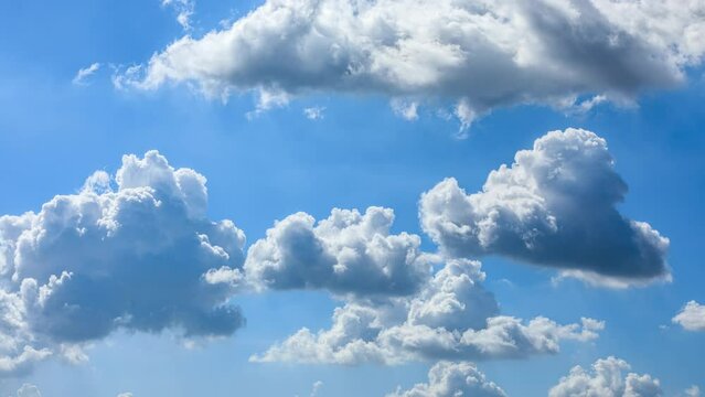 White clouds change shapes on the blue sky. Sky clouds time lapse.