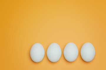 Four white chicken eggs on yellow background top view. Creative food minimalistic background.