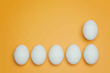 Six white chicken eggs on yellow background top view. Creative food minimalistic background.