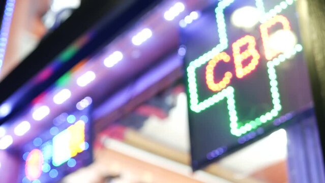 Neon sign in smoke shop, legalized cbd oil or medical cannabis in store, California USA. Legal sale of cannabidiol, weed, hemp, marijuana, ganja or hashish in dispensary. Cannabinoids in drugstore.