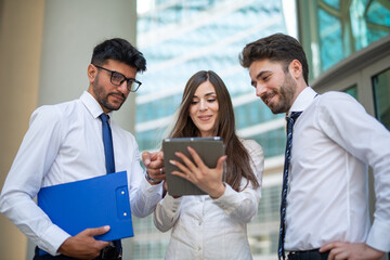 Business people using a tablet outdoor