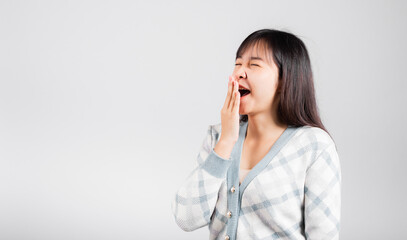 Sleepy woman closed eyes emotions tired and sleepy her yawning cover mouth open by hand, Portrait Asian beautiful young female sleep and energy studio shot isolated on white background with copy space