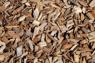 Wood chip bark chippings having been shredded for use as a garden mulch by the lumber timber industry which can be used as an abstract texture background, stock photo image