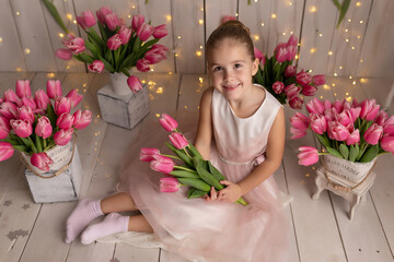 Cute girl with tulips flower bouquet. Mother's Day, March 8, International Women's Day concept
