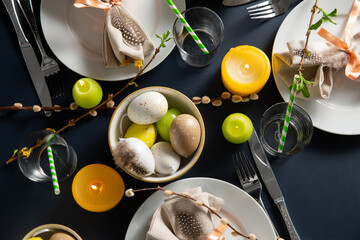 easter, holidays, tradition and object concept - close up of dinner party table serving over black...
