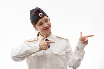 Beautiful young female Russian police officer in dress uniform shows signs with her hands on a...