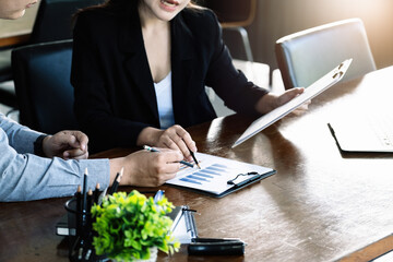 Teamwork concept, consultation, male economist holding pen pointing to budget, finance and...