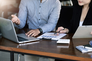 Teamwork concept, consultation, male economist holding pen pointing to budget, finance and...