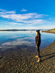 A girl on the White Sea coast on a sunny day. Karelia. Russia. SEPTEMBER 2021