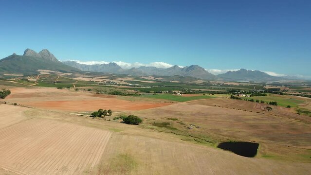 View Across Vineyards With Simonsberg Mountain In The Background In South Africa - aerial drone shot