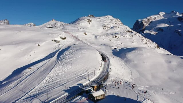 Red swiss train running through the snow. High quality 4k footage