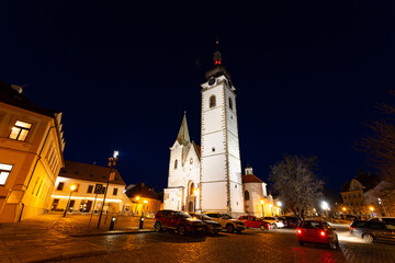 Gothic church of the Nativity of the Blessed Virgin Mary and clock tower. Pisek - town in South Czechia.