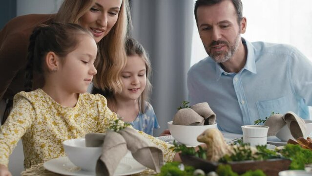 Caucasian family of five spending time over table on easter time. Shot with RED helium camera in 8K.