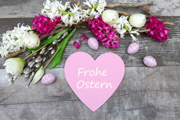 Naklejka na ściany i meble Osterkarte: Blumen und Zweige mit dem Schriftzug Frohe Ostern auf einem Herz.