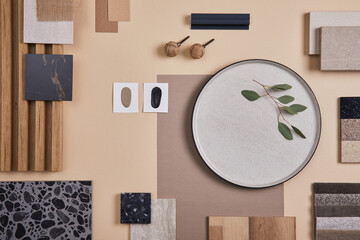 Creative flat lay composition of interior designer and architect moodboard. Textile and paint samples, lamella panels and lastrico tiles. Beige, black and green color palette. Copy space. Template.