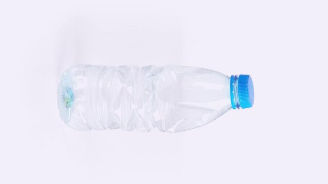 Vertical Plastic bottle crushing time lapse on white background Plastic pollution concept endless loop