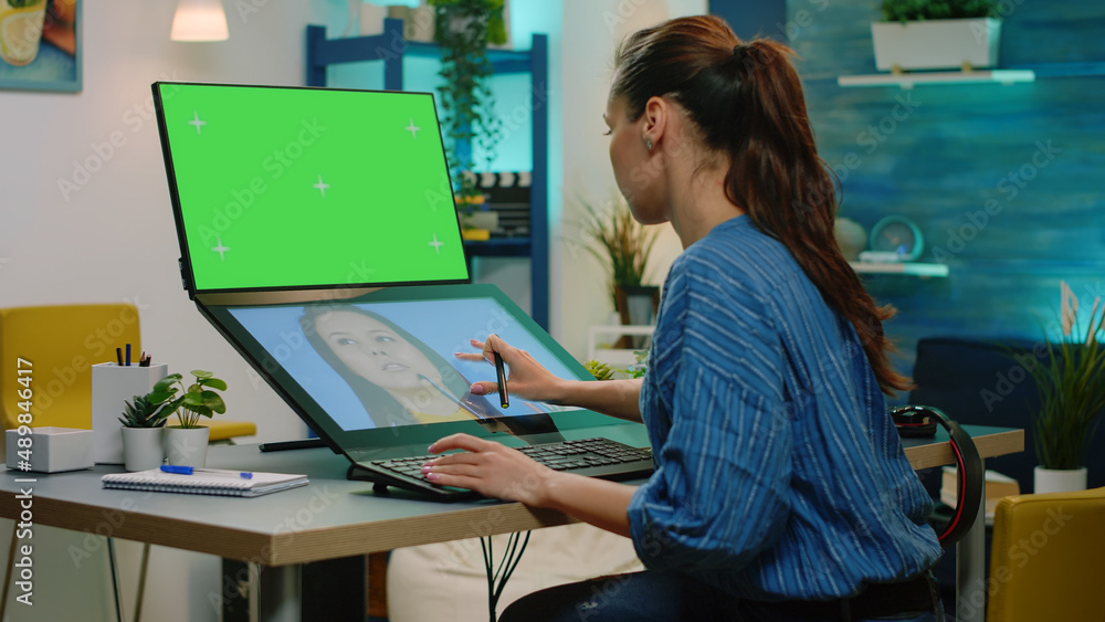 Poster editor retouching pictures and having green screen on computer. photographer using touch screen for 