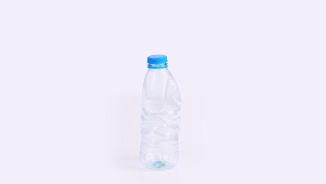Plastic bottle crushing time lapse on white background Plastic pollution concept endless loop