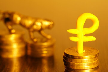 A metaldic tiger and a ruble figurine in close-up. The fall of the currency.