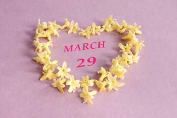 Calendar for March 28: number 28, the name of the month of March in English in a heart made of...