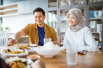 friends having fun eating lunch together at home with traditional food