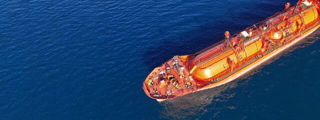 Aerial drone ultra wide top down photo of industrial LPG gas tanker ship anchored in deep blue sea