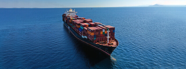 Aerial drone ultra wide photo of industrial container cargo vessel leaving logistics unloading...