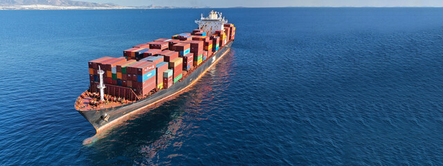 Aerial drone ultra wide photo of industrial container cargo vessel leaving logistics unloading...