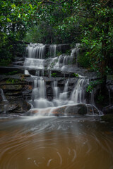 Fototapeta na wymiar A small waterfall cascade in the rainforest.