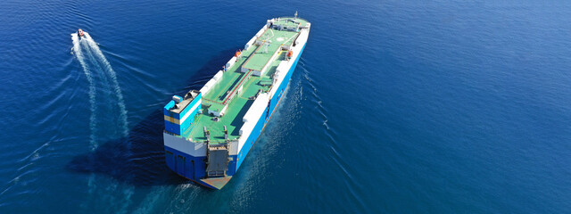Aerial drone ultra wide photo of huge car carrier ship RO-RO (Roll on Roll off) cruising in...