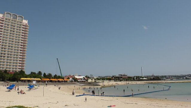 CHATAN-CHO, OKINAWA, JAPAN - AUGUST 2021 : View of Chatan sunset beach (Ocean or sea). Wide view, time lapse shot in daytime. Summer holiday, vacation and resort concept video.