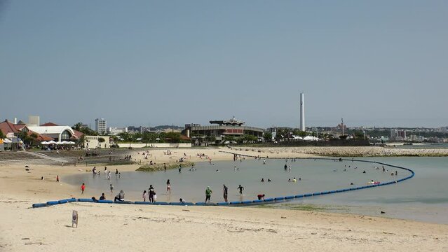 CHATAN-CHO, OKINAWA, JAPAN - AUGUST 2021 : View of Chatan sunset beach (Ocean or sea). Wide view, time lapse shot in daytime. Summer holiday, vacation and resort concept video.