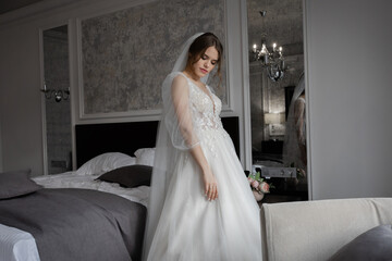 A girl in a wedding dress, a bride with flowers, delicate details.