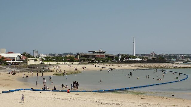 CHATAN-CHO, OKINAWA, JAPAN - AUGUST 2021 : View of Chatan sunset beach (Ocean or sea). Wide view, time lapse shot in daytime. Summer holiday, vacation and resort concept video.