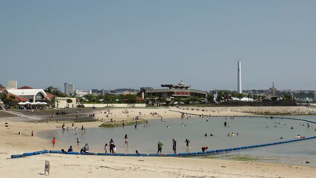 CHATAN-CHO, OKINAWA, JAPAN - AUGUST 2021 : View of Chatan sunset beach (Ocean or sea). Wide view, time lapse shot in daytime. Summer holiday, vacation and resort concept video.